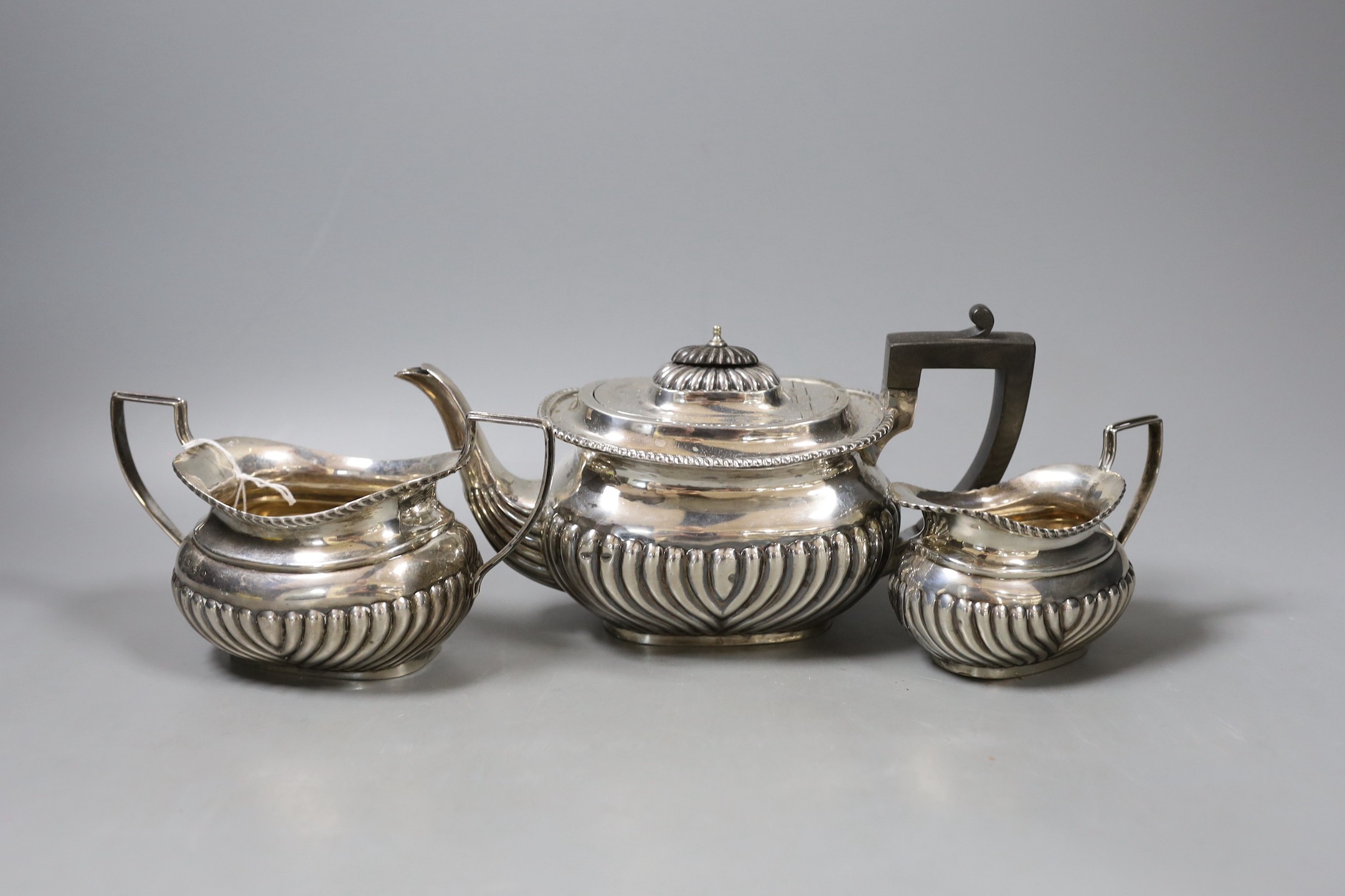 A matched late Victorian demi-fluted silver three piece tea set, Birmingham, 1896/7